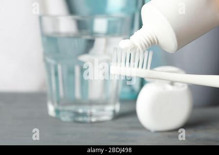 Toothbrush with toothpaste on background with dental care tools, close up Stock Photo