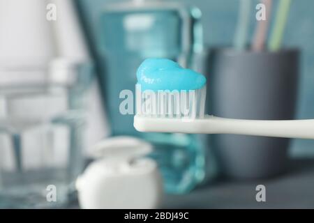 Toothbrush with toothpaste on background with dental care tools, close up Stock Photo