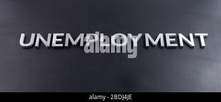 the word unemployment laid with aluminium letters on matte black flat surface Stock Photo