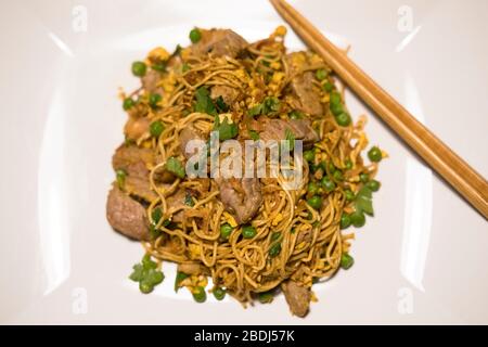 Lisbon, Portugal - 12 May 2018 : Pork and noodles stir fry Stock Photo