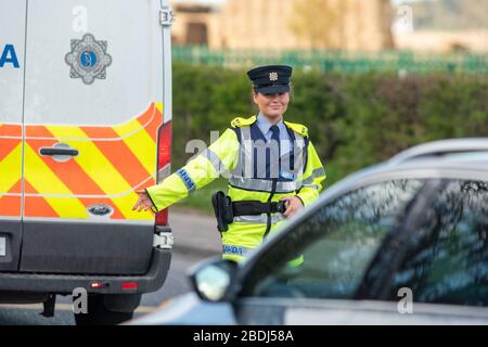 Ashbourne, Ireland. 08th Apr, 2020. Members of An Garda Síochána, more commonly referred to as the Gardaí or 'the Guards', is the police service of the Republic of Ireland seen today manning a checkpoint outside Ashbourne, County Meath to ask drivers where they are going or coming from. The Irish Government has given An Garda Síochána sweeping new powers to enforce restrictions on public movement due to the Covid-19 pandemic.Gardaí can now arrest and detain people they deem to be non-compliant with restrictions in place on public movement. These extraordinary enforcement powers are in place fr Stock Photo