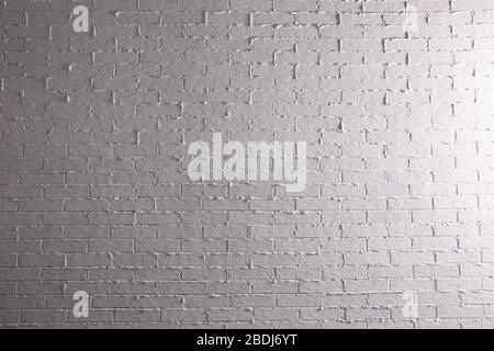 Brick painted white and properly illuminated reflects the interesting climate of its structure. Stock Photo