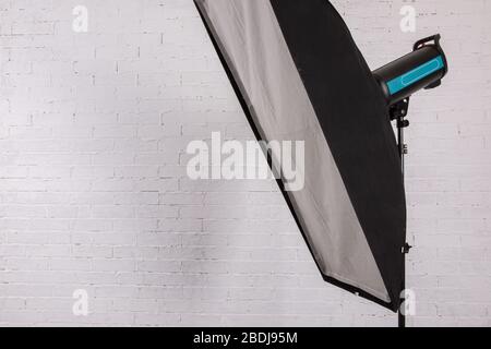 A studio flash fires a lot of light at a time when shooting. Stock Photo