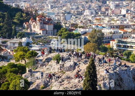 ATHENS, GREECE - DECEMBER 17, 2019: People make photos of Acropolis and Athens from Areopagus hill view point Stock Photo