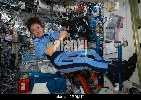 ISS - 31 March 2020 - NASA astronaut and Expedition 62 Flight Engineer Jessica Meir is pictured working on laptop computer maintenance aboard the Inte Stock Photo