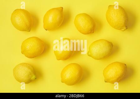 Ripe juicy lemons on yellow back. Top view. Stock Photo