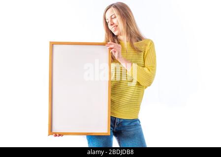 Woman holding a white sign, ideal template for mockups, written phrases or drawings Stock Photo