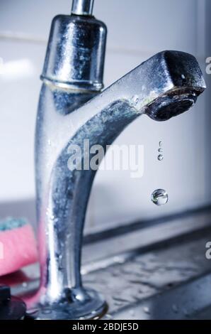 Water Dripping from Steel Faucet Stock Photo