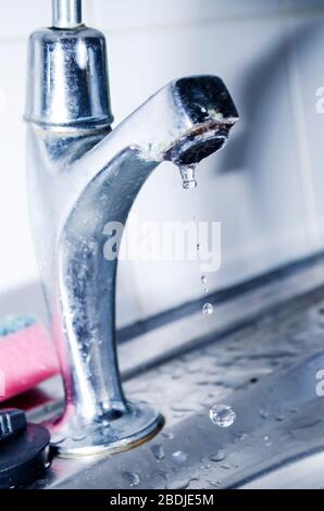 Water Dripping from Steel Faucet Stock Photo