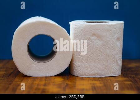 two roll of white toilet paper on wood desk table Stock Photo