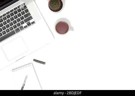 White table office desk with laptop, cup of coffee and supplies. Top view with copy space, flat lay. Stock Photo