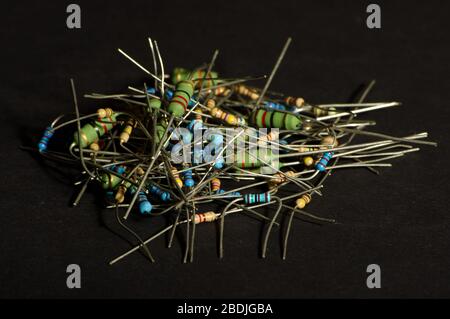 Many small through hole resistors isolated on the dark background Stock Photo