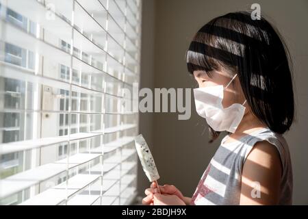 Kid stay at home during summer, no outdoors activity Stock Photo