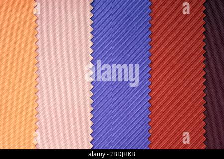 Samples of fabrics in pastel shades. Blue, red, yellow piece of fabric with texture. Lightweight fabric made of synthetic fibres (nylon or polyester) Stock Photo