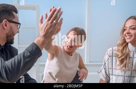 close up.business team giving each other a high five. Stock Photo