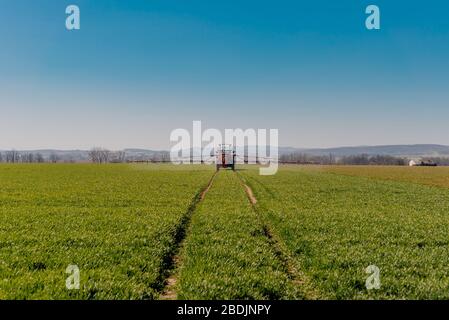 Tractor Spraying Herbicides on Field Agriculture Stock Photo