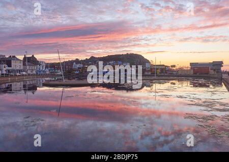 Hastings sunrise over the boating lake on the seafront promenade, East Sussex, UK Stock Photo