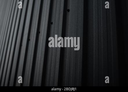 Black Corrugated metal sheet surface of the wall. Galvanize steel background. Stock Photo