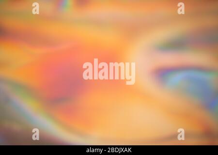 Abstract blurred holographic iridescent foil background. Wallpaper trendy gradient Stock Photo
