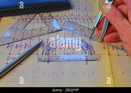 Electrical engineer workplace - electrotechnical project, rulers, and divider compass. Construction and electrotechnology concept. Engineering tools Stock Photo