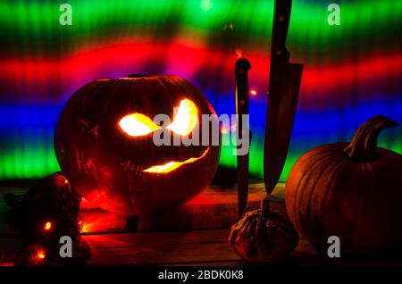 Illuminated Halloween Carved Pumpkins with Light and Knife Stock Photo