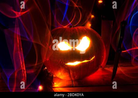 Illuminated Halloween Carved Pumpkins with Light and Knife Stock Photo