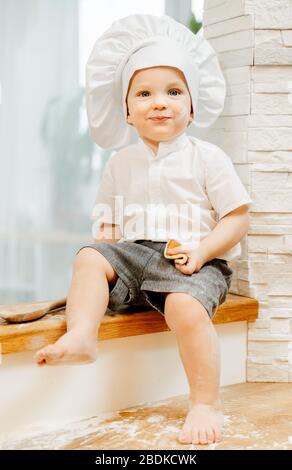 Positive little charming caucasian boy in white cap Stock Photo