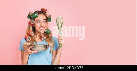 Housewife going to cook cakes with bowl and whisk Stock Photo