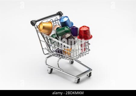 horizontal view of several coffee capsules of espresso in a shopping cart isolated on white background Stock Photo