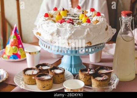 Home birthday celebration with homemade cake and cookies cups Stock Photo