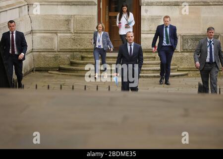 (200409) -- LONDON, April 9, 2020 (Xinhua) -- British Foreign Secretary Dominic Raab(C) arrives at 10 Downing Street for a meeting in London, Britain on April 8, 2020. During Wednesday's Downing Street daily press briefing, Chancellor of the Exchequer Rishi Sunak said Prime Minister Boris Johnson's condition is improving and remains in intensive care. Johnson was admitted to St Thomas' Hospital in London with 'persistent symptoms' on Sunday night, 10 days after testing positive for COVID-19. He was moved into intensive care on Monday night after his coronavirus symptoms worsened. (Photo by Stock Photo