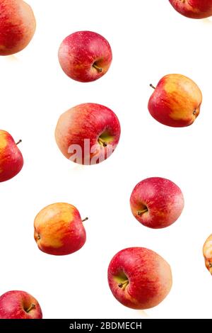 Large ripe red apples falling from top to bottom. Open composition. Close-up. Isolated on white background. Stock Photo