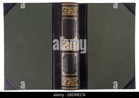 Old opened book's cover isolated on white. Textile binding with leather accents and gold embossed pattern. Stock Photo