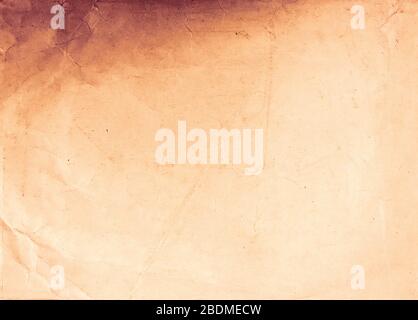 Old burned paper texture. Vintage paper background. Warm toned photo. Stock Photo