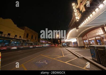 Ballarat Australia - March 15 2020; Wide angle street scene of illuminated art deco style Regent Theatre on Mair Street at night  under street light i Stock Photo