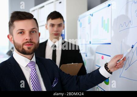 Smiling handsome bearded caucasian man in office telling something important Stock Photo