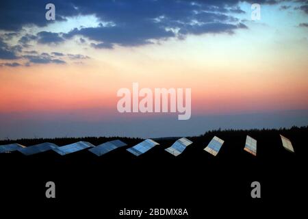 Kaufbeuren, Germany. 09th Apr, 2020. The morning sky is reflected on a solar system shortly before sunrise. Credit: Karl-Josef Hildenbrand/dpa/Alamy Live News Stock Photo