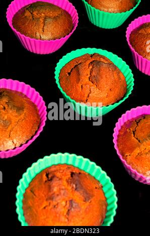 Reddish chocolate cupcakes on a black background vertical orientation Stock Photo