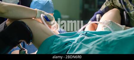 Surgeon doctor in operating room during gynecological biopsy Stock Photo