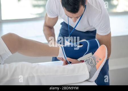 Nice young doctor holding a special bandage Stock Photo