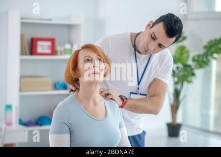 Nice aged woman having a neck massage Stock Photo