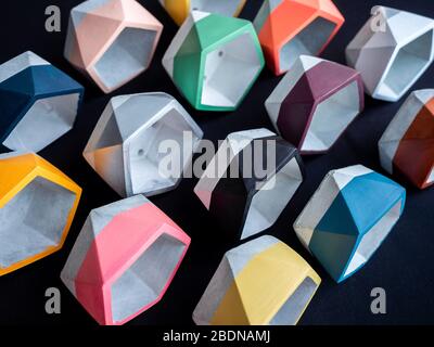 Cactus pot. Concrete pot. Empty colorful pentagon concrete planters on dark background. Stock Photo