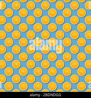 Orange slices seamless pattern on blue background. Minimal flat lay top view food texture. seamless background of fresh orange slices Stock Photo