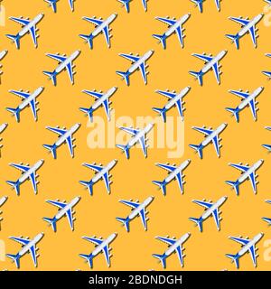 Pattern, seamless model airplane texture, plane on yellow background. Summer travel or vacation pattern. Creative composition made with passenger plan Stock Photo