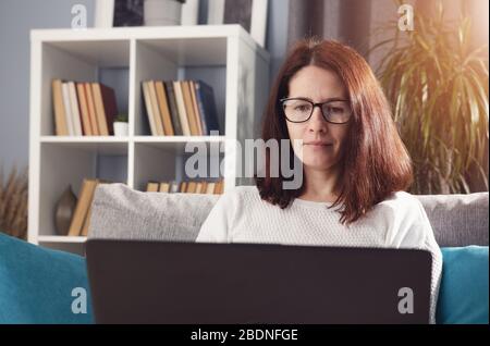 Middle-aged brunette working from home Stock Photo