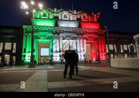 The facade of Milan Central Station illuminated with the Italian flag, Milan, April 2020. For the first time in 90 years of history, Milan Central Station is illuminated with the Italian flag - the Tricolore - by Gruppo Ferrovie dello Stato Italiano and Milano Centrale to pay homage to the city from one of its iconic locations.
