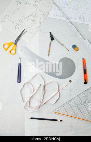Sewing pattern with tools like scissors and ruler from above Stock Photo