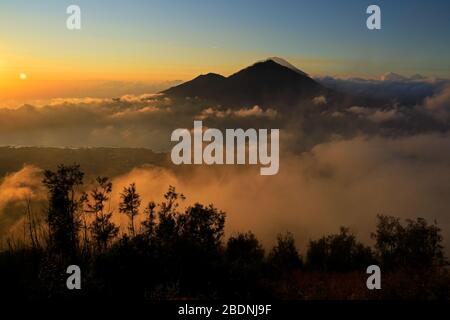 Scenic view of clouds and mist at sunrise from the top of mount Batur (Kintamani volcano), Bali, Indonesia Stock Photo