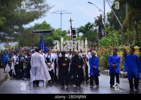 Chapel elders lead congregation to bring Tuan Ma (Mother Mary) statue to Larantuka Cathedral during Holy Week procession on Good Friday in Indonesia. Stock Photo