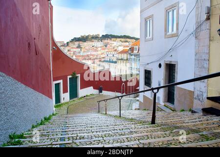 Empty street and skyline of Lisbon Old Town with Lisbon Castle on a top of a hill. Portugal Stock Photo